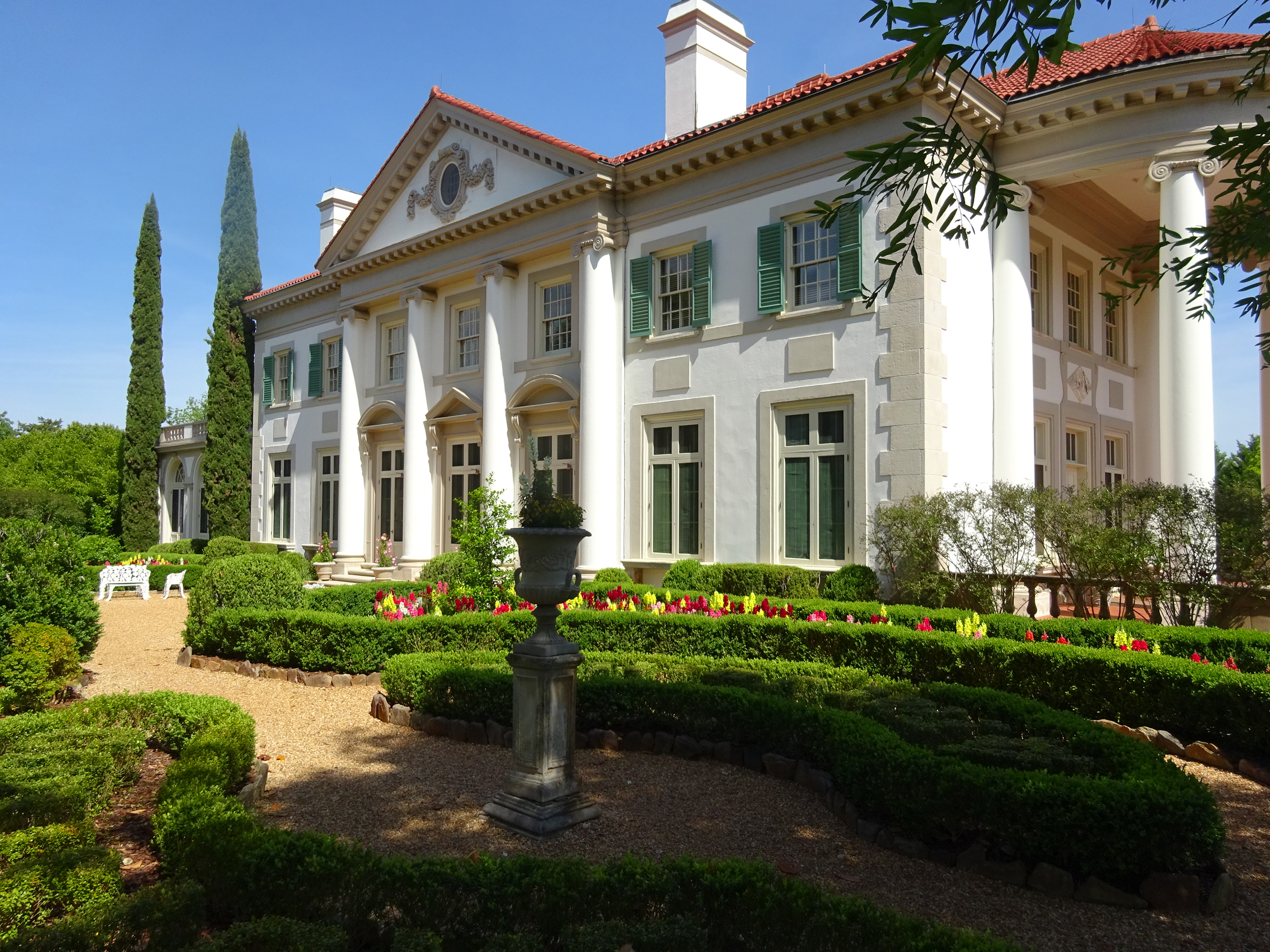Exterior of a large stucco building on the grounds of Hills & Dales Estate