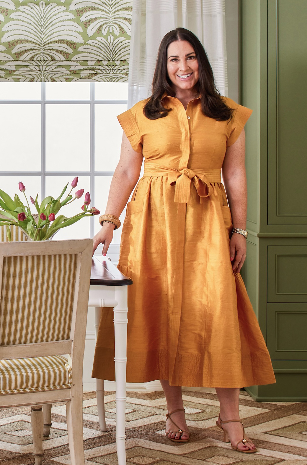 portrait of Courtney Davis standing in a dining room