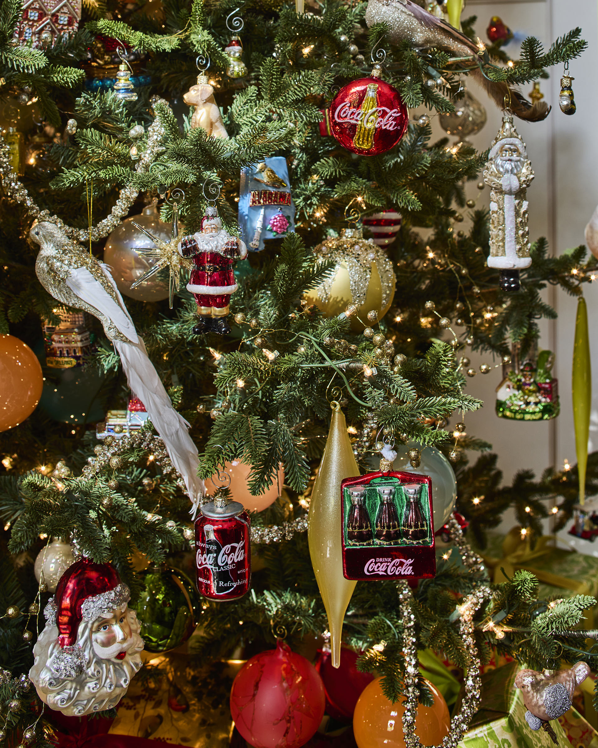 Holiday tree decorated with Coca Cola and travel ornaments in Greystone home renovation