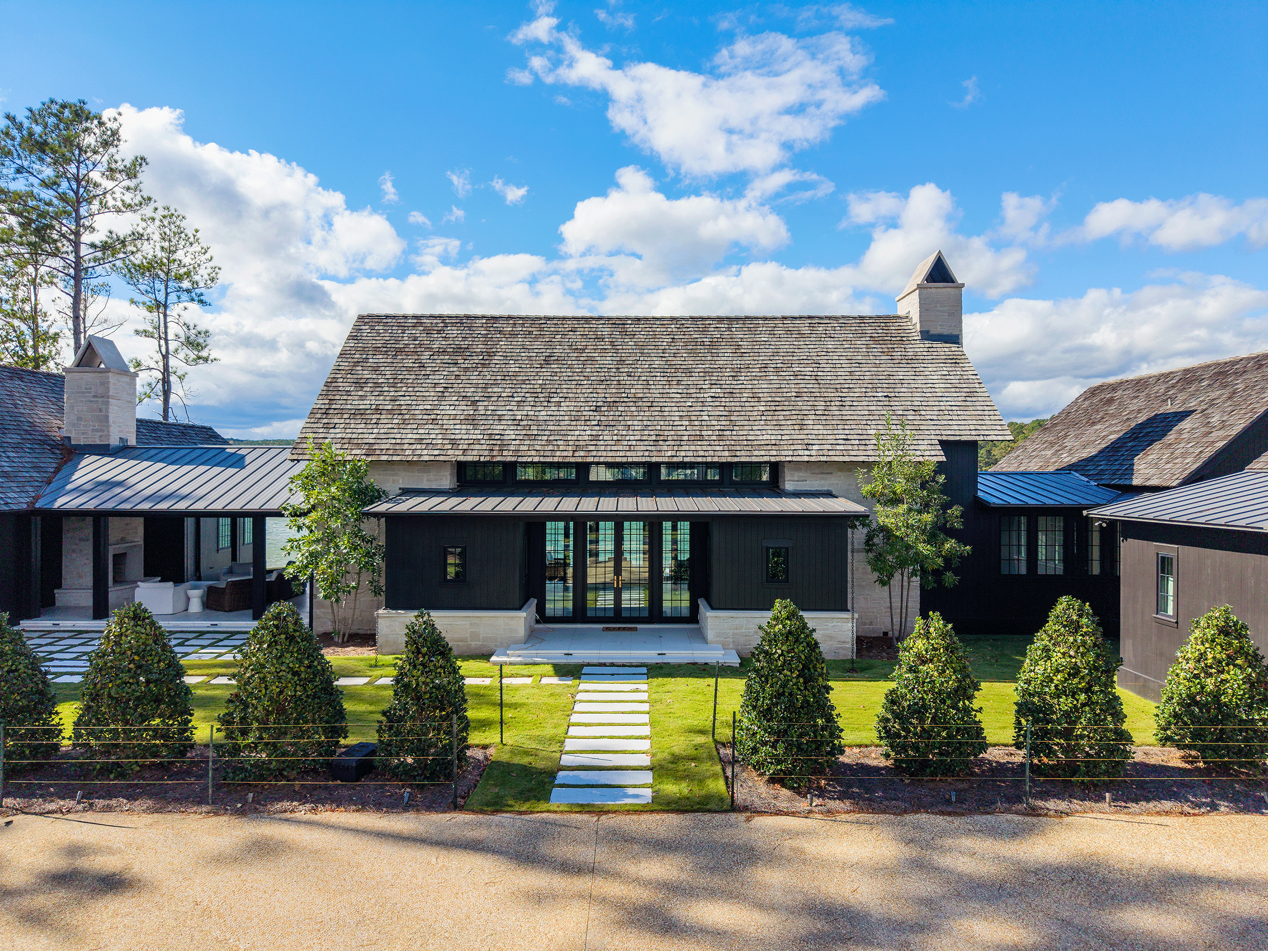 Top-down aerial view of the Blackwell home showing the architectural footprint following the natural curve of the Lake Martin shoreline.