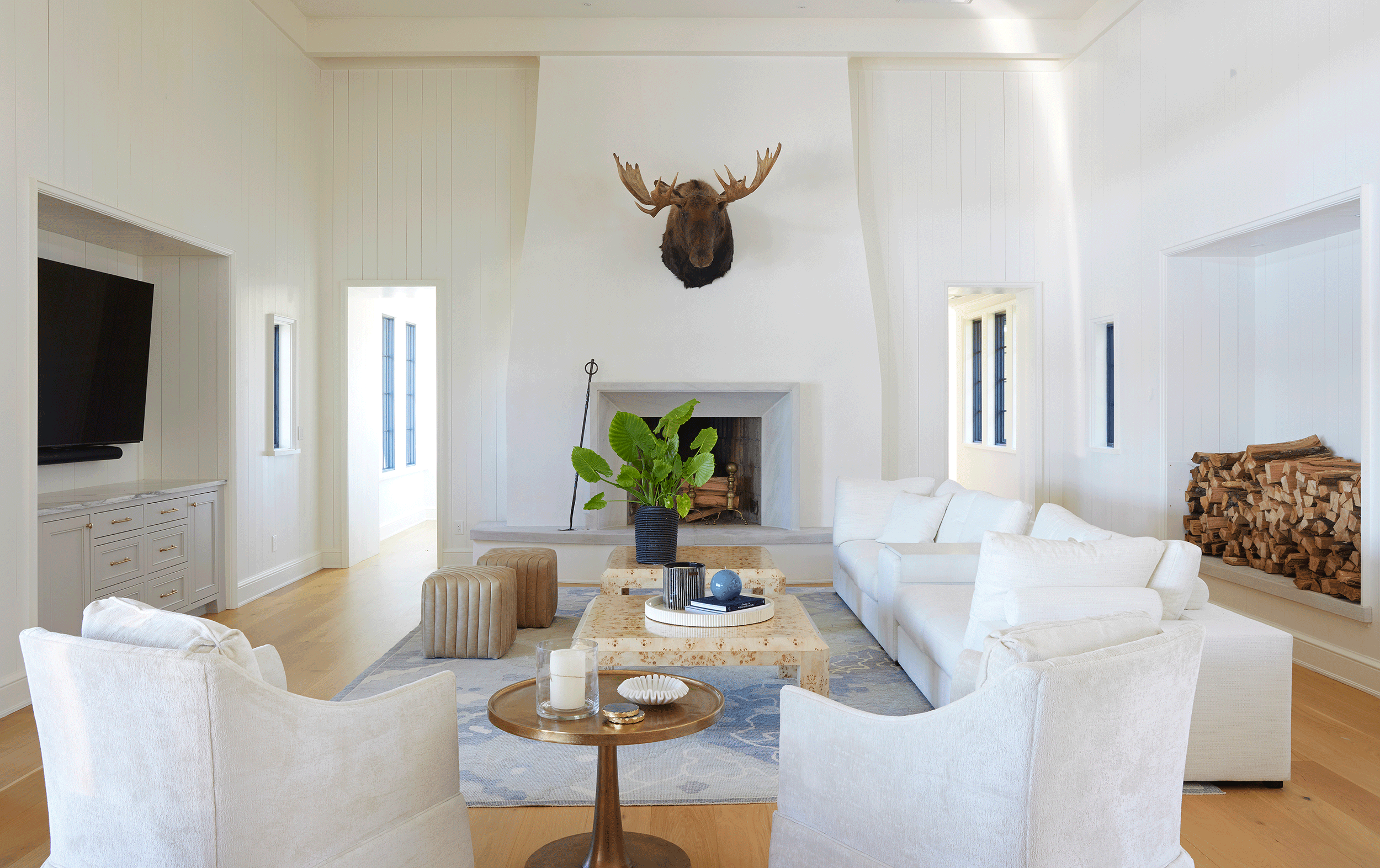 Interior view of a Lake Martin living room showing how deep roof overhangs and transom windows diffuse direct sunlight.