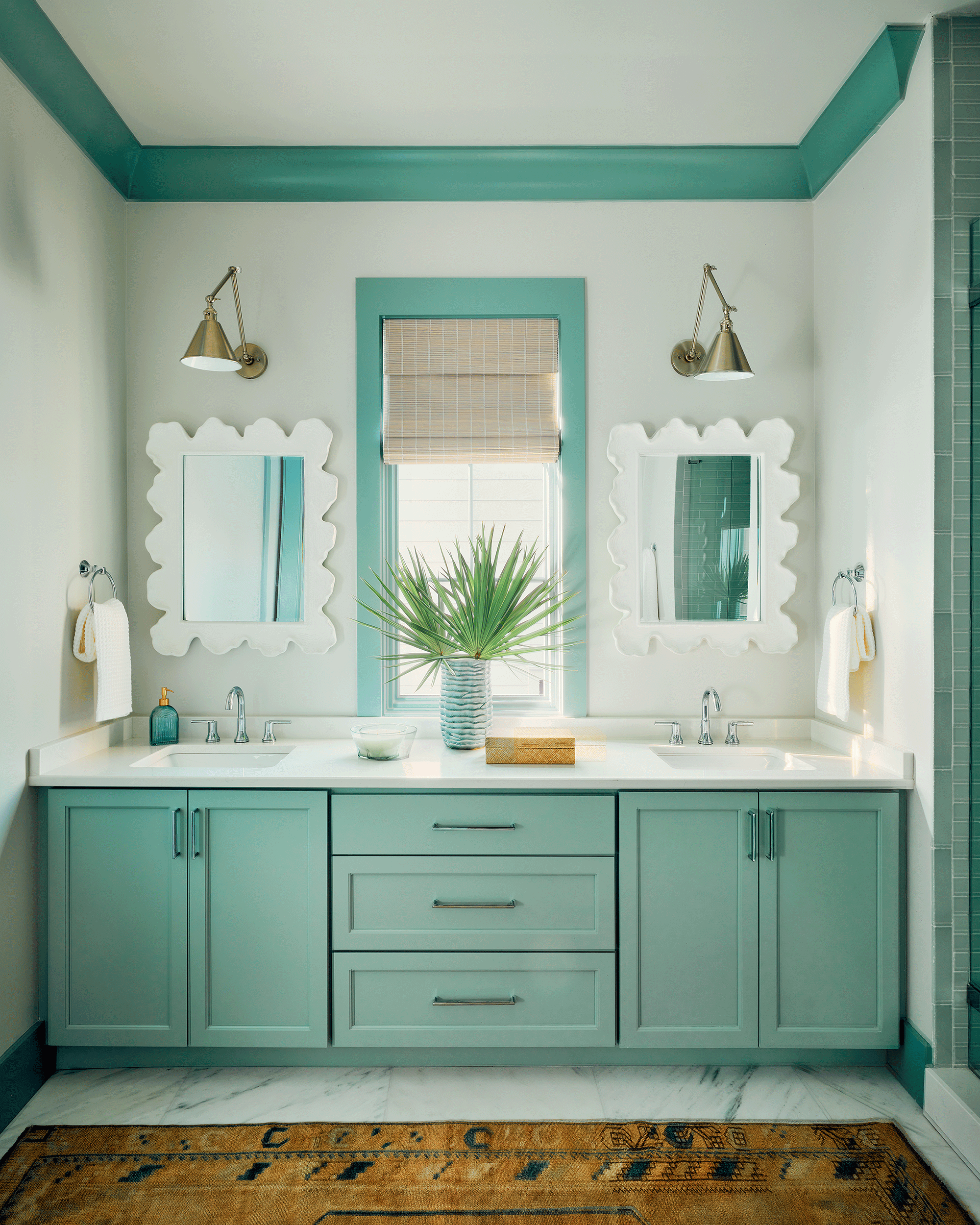 Modern bathroom design with vertical-stack emerald green tiles, offering high-end finishes for multiple families sharing a vacation home.
