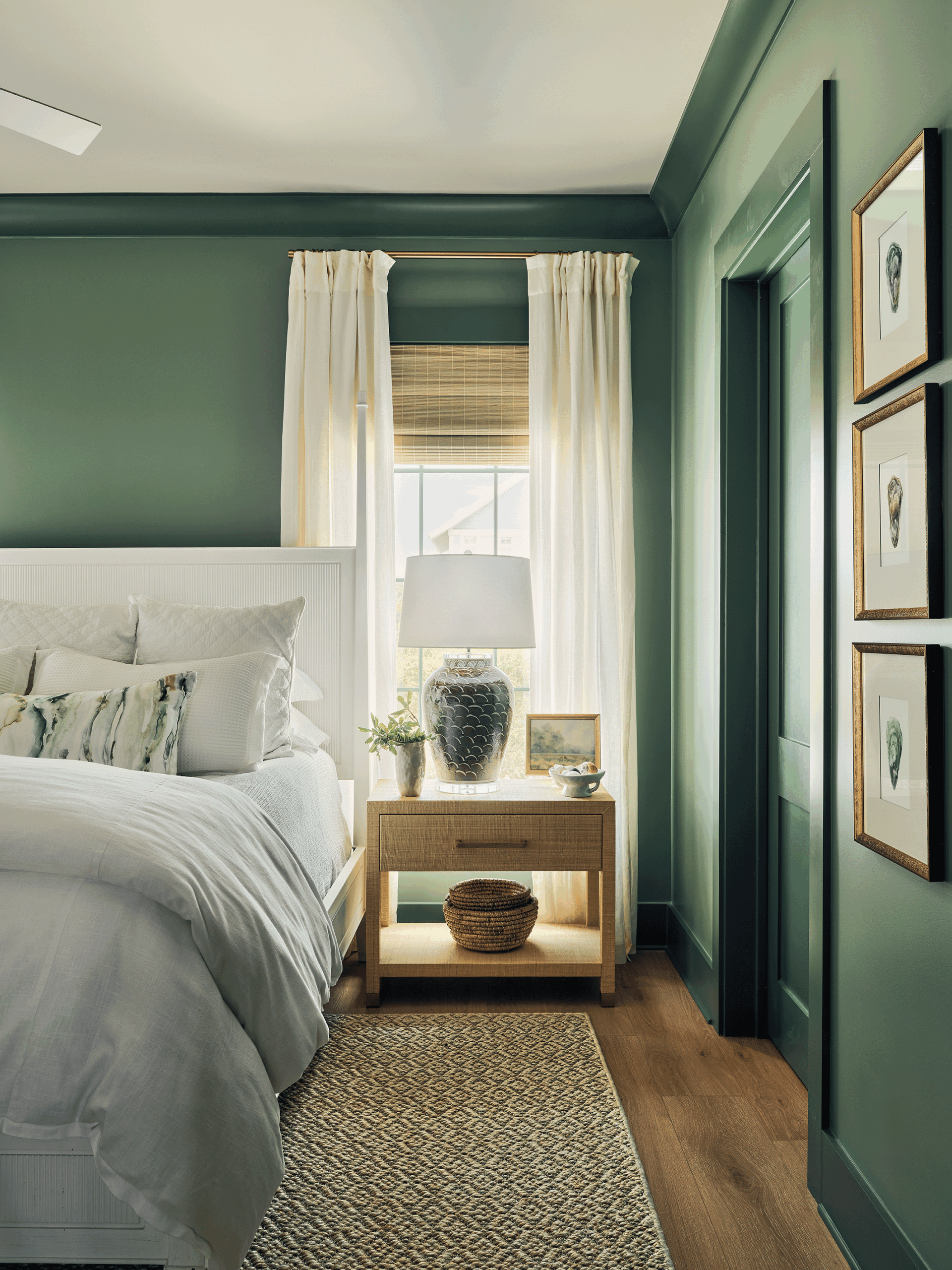 Bedside vignette with natural textures and linen drapery, showcasing the quiet personal spaces essential to sharing a vacation home.
