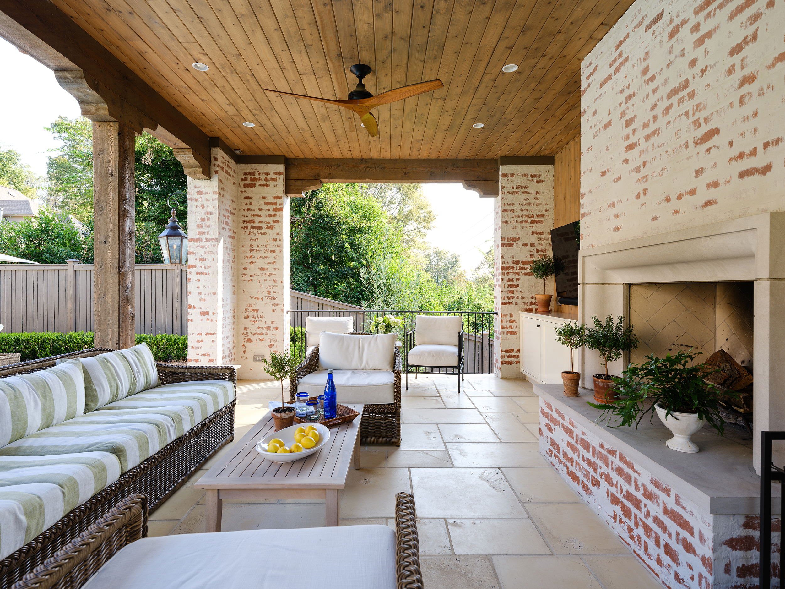 Interior of the Mountain Brook pool house showing built-in cabinet storage and a seating area for entertaining.