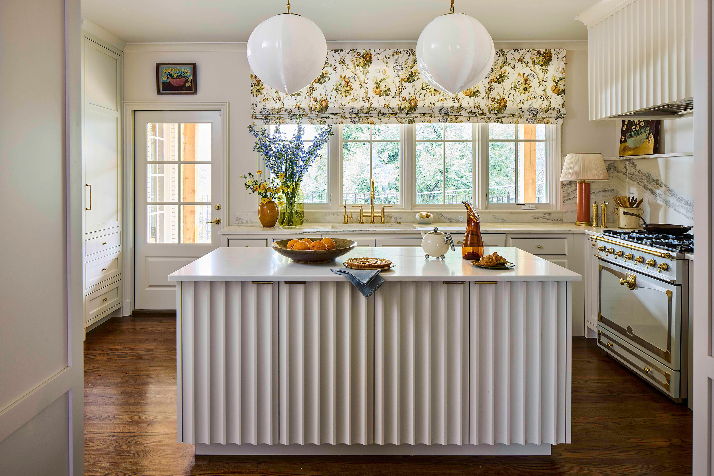 Kitchen island with waterfall-edge Alabama white marble peninsula from Cottage Supply, providing additional seating in Kelly Neely designed kitchen.