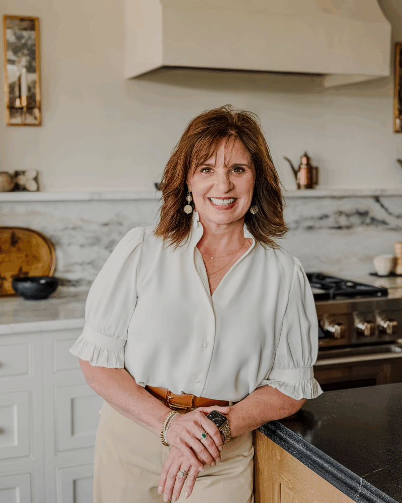 Interior designer Leslie Davis stands in her winning project, a departure from the traditional white kitchen