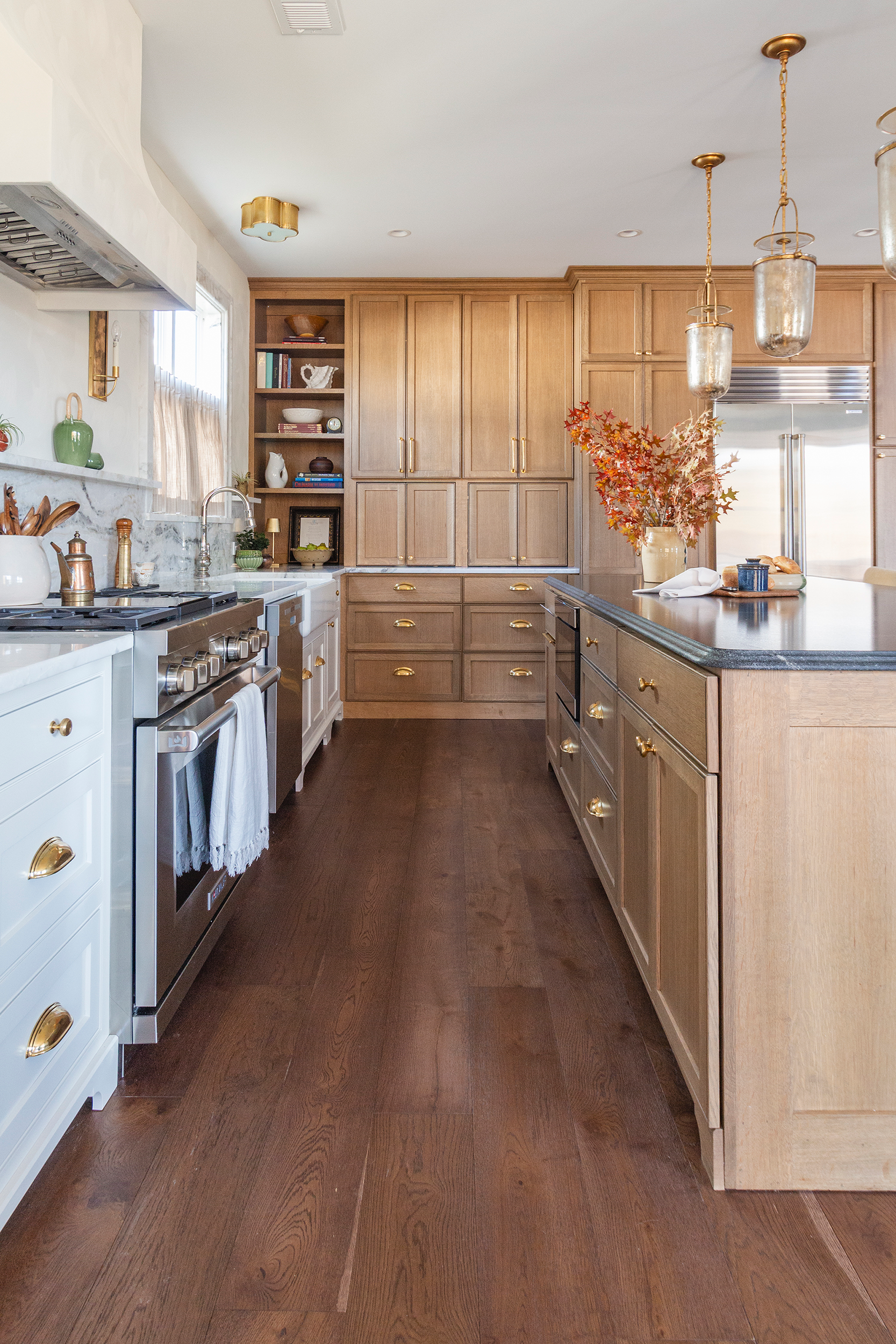 Spacious white kitchen remodel with floor-to-ceiling cabinetry and hidden storage