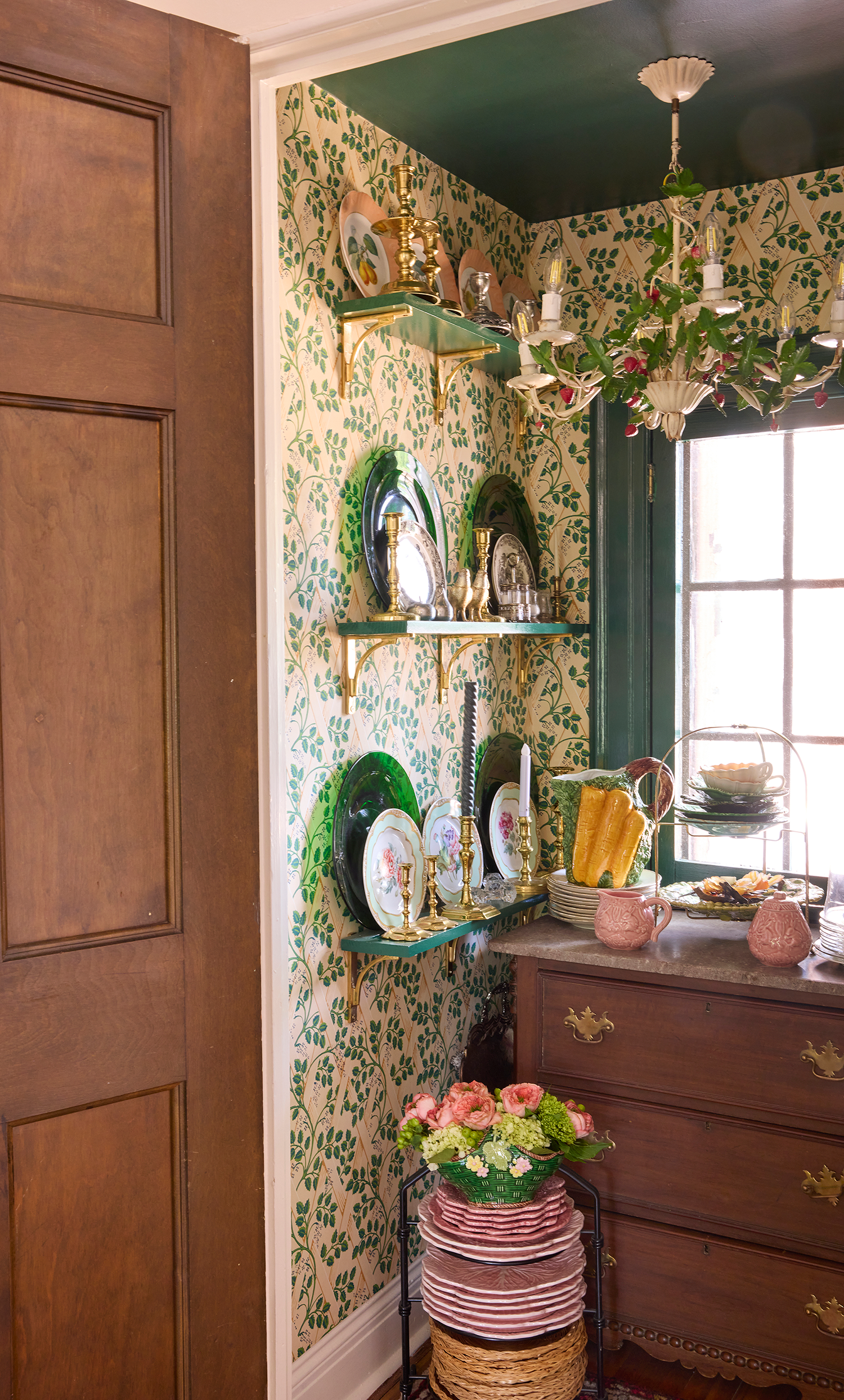 Converted storage closet turned jewel box china pantry in a historic Athens Alabama house displaying fine porcelain and cabbage plates.