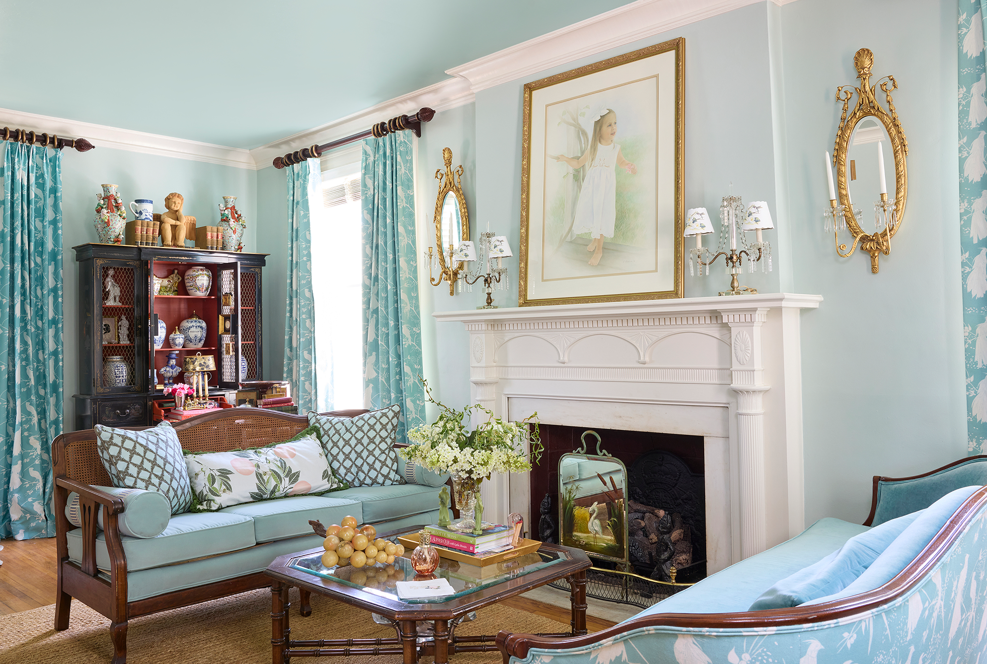 Traditional living room interior of a 1929 Georgian house featuring custom drapery, decorative pillows, and antique furnishings.
