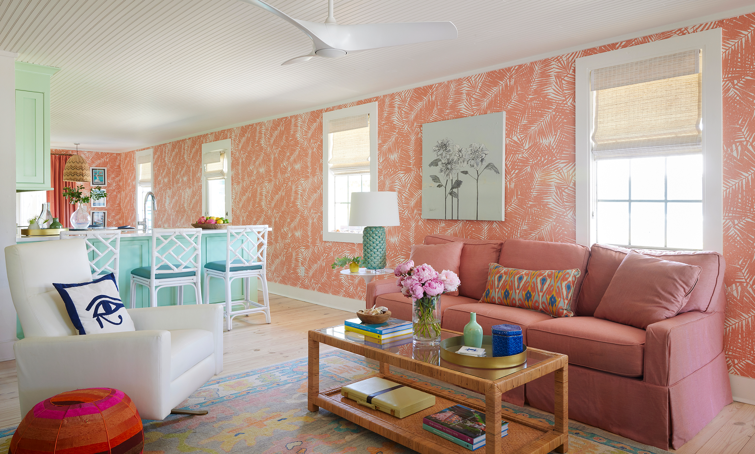 Light-filled Panama City Beach cottage living room with coastal decor, woven furniture, and ocean breeze view.