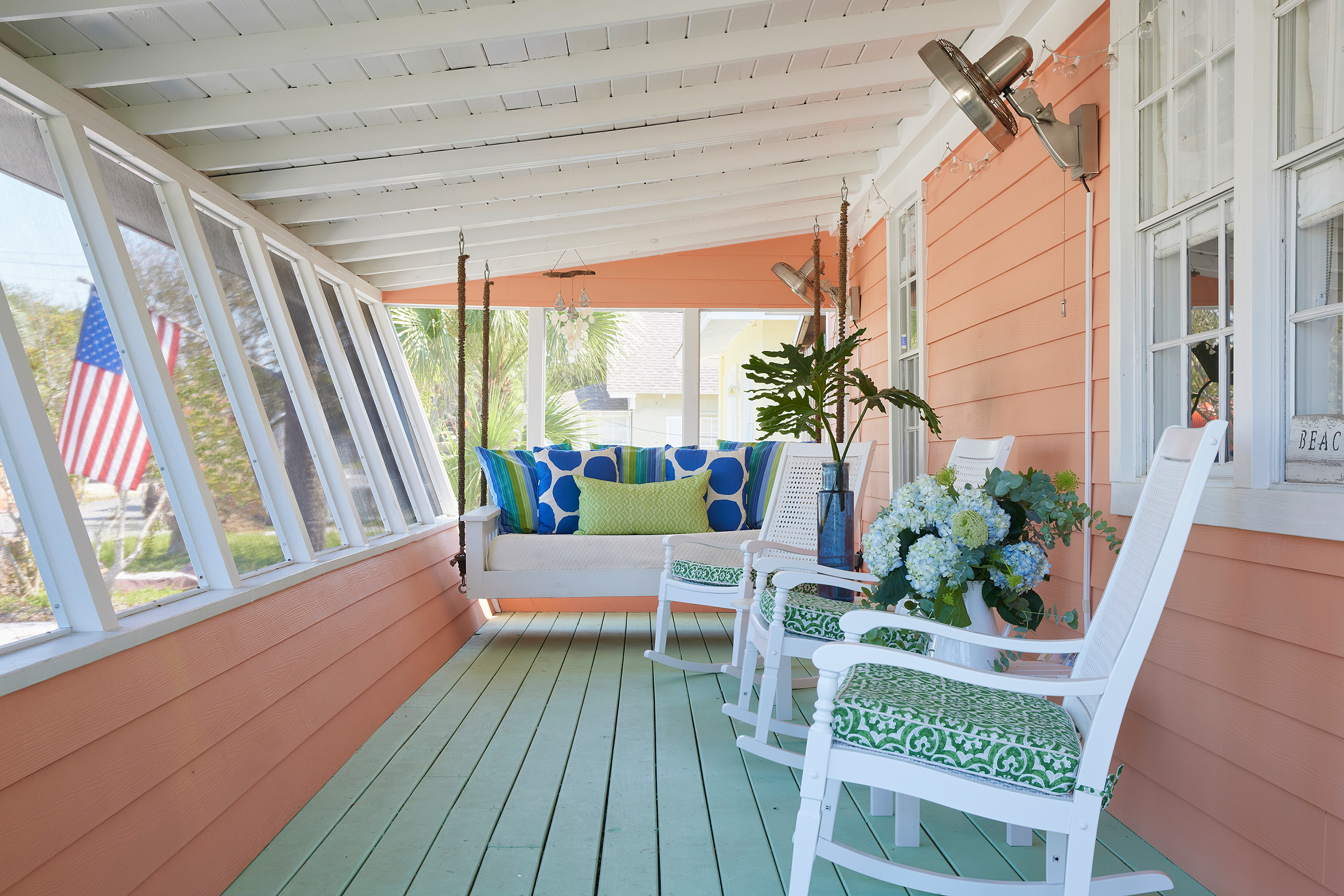 A 1940s Panama City Beach cottage with a screened front porch and swinging daybed.