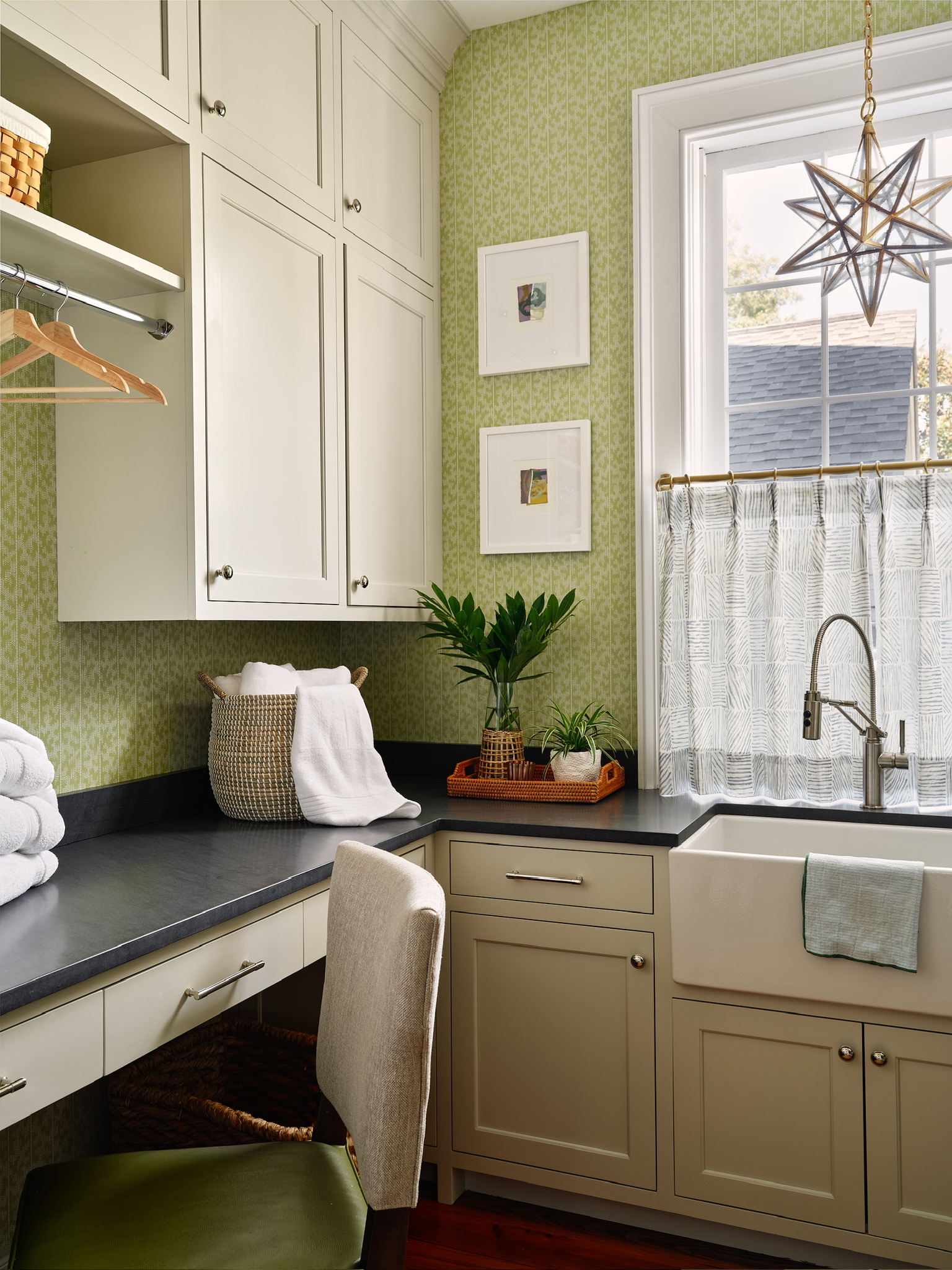Kelly Butler laundry room featuring Schumacher 'Montpellier' wallpaper and Visual Comfort lighting.