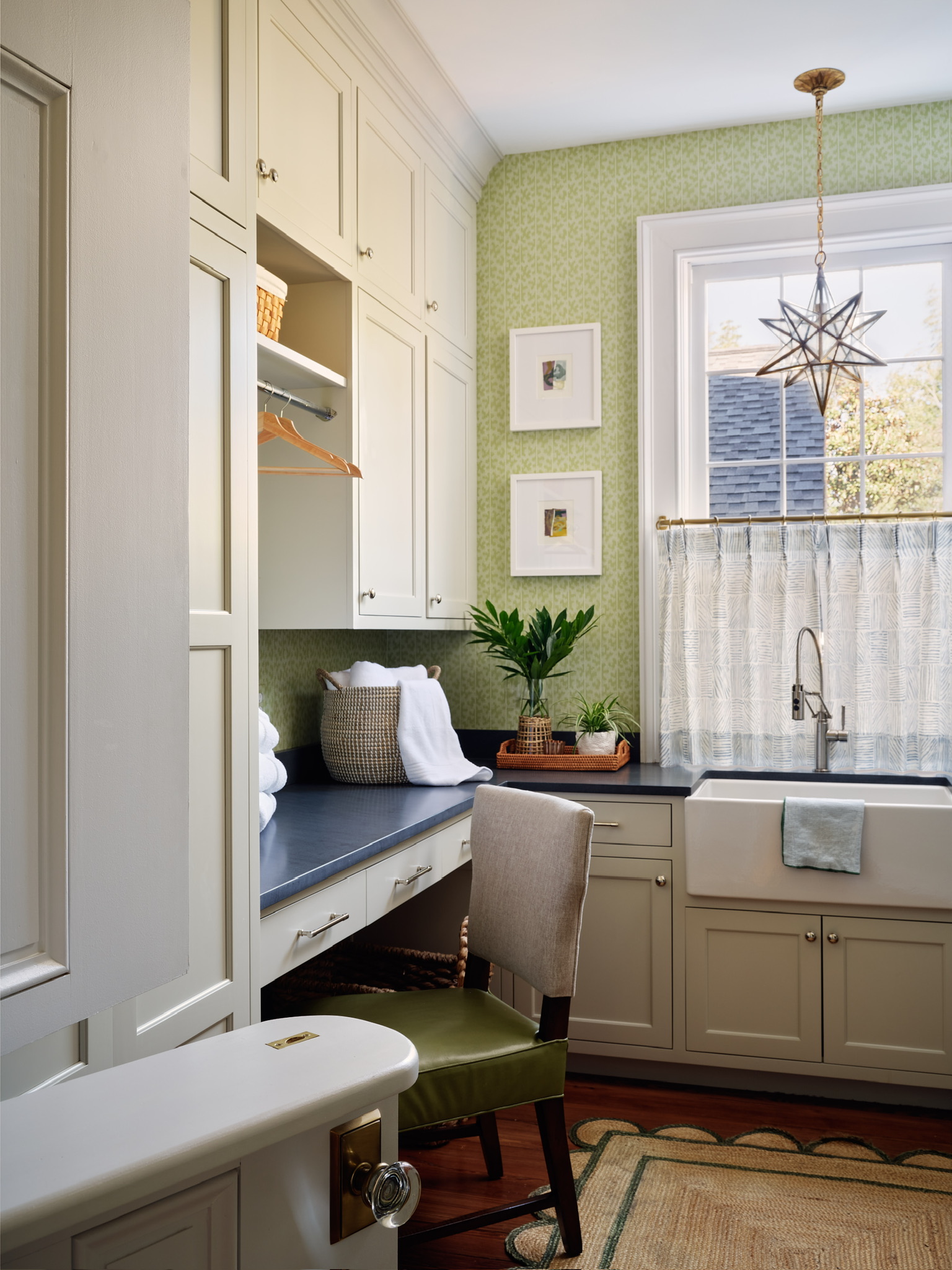 Farmhouse task sink in a Kelly Butler-designed laundry room with brass faucet.