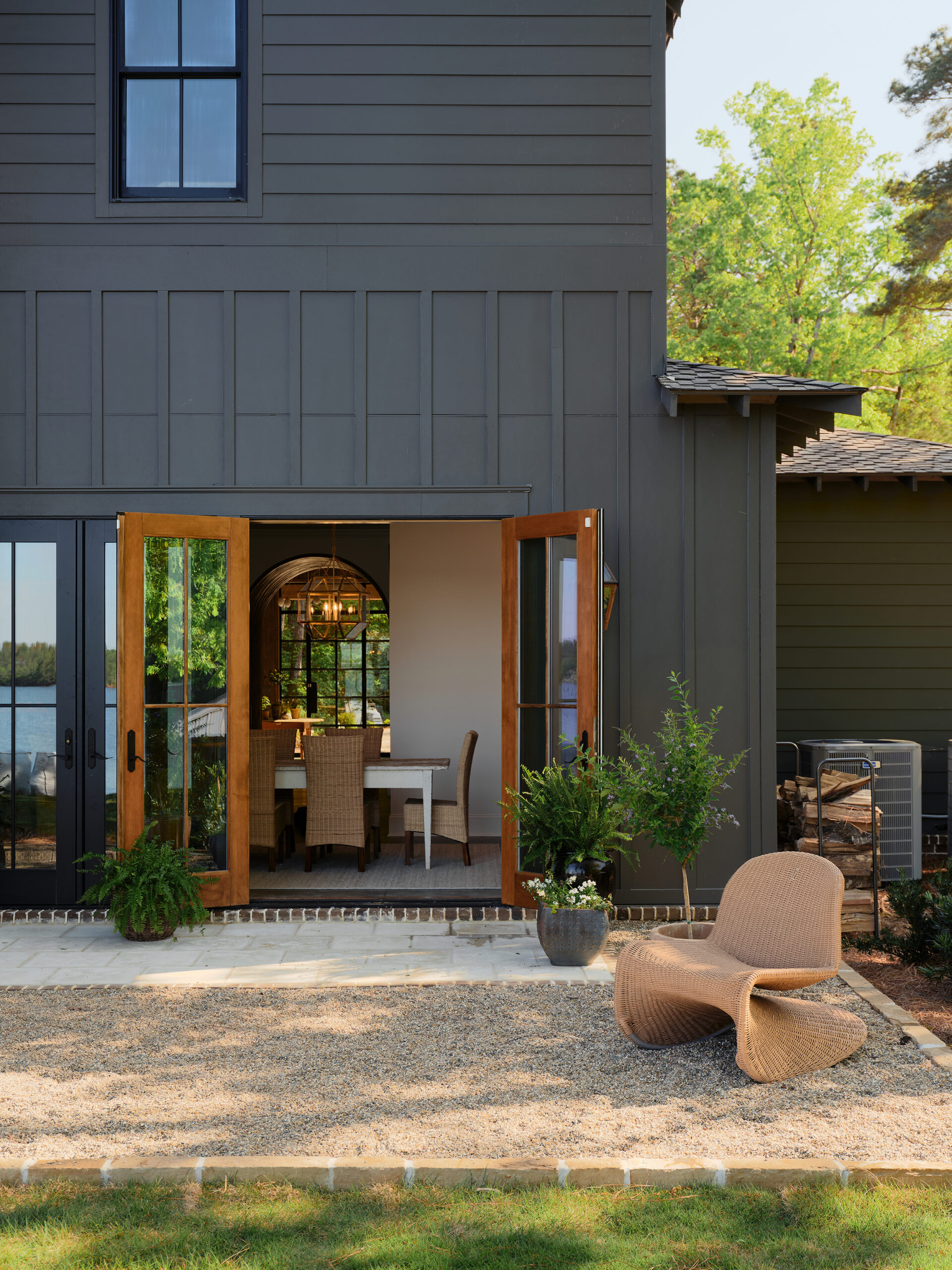 French doors extend the dining room outdoors to a gravel patio in a Lake Martin home