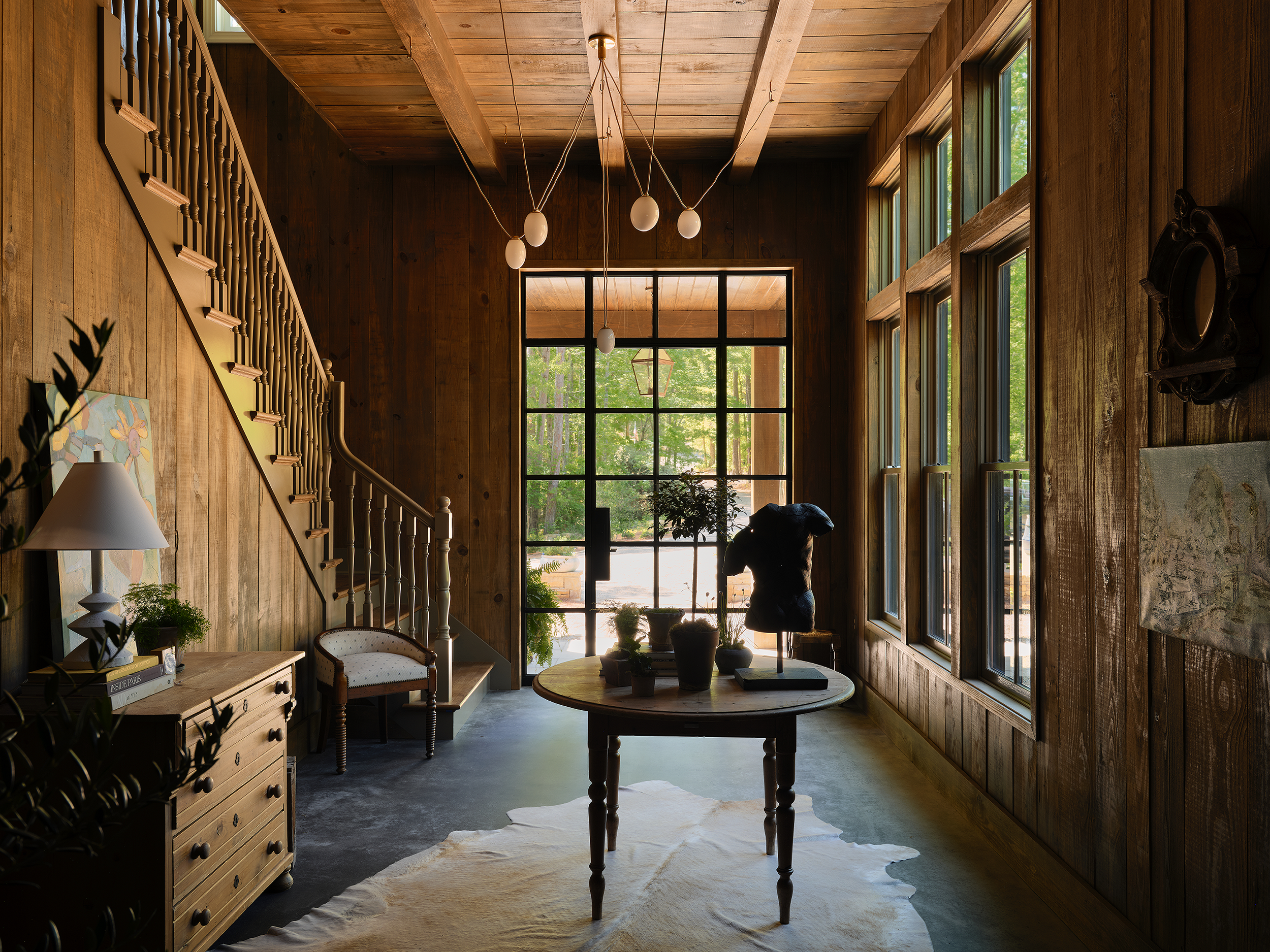 Lake Martin foyer makes an immediate impression with the walls and ceiling wrapped in rough-sawn pine