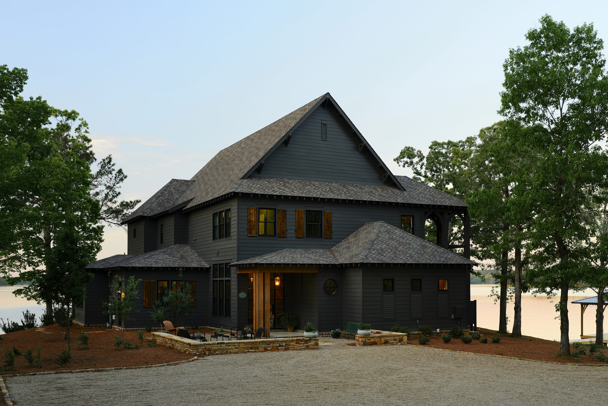 Rustic shutters, open rafter tails, and gable brackets add texture and dimension to this Lake Martin retreat.
