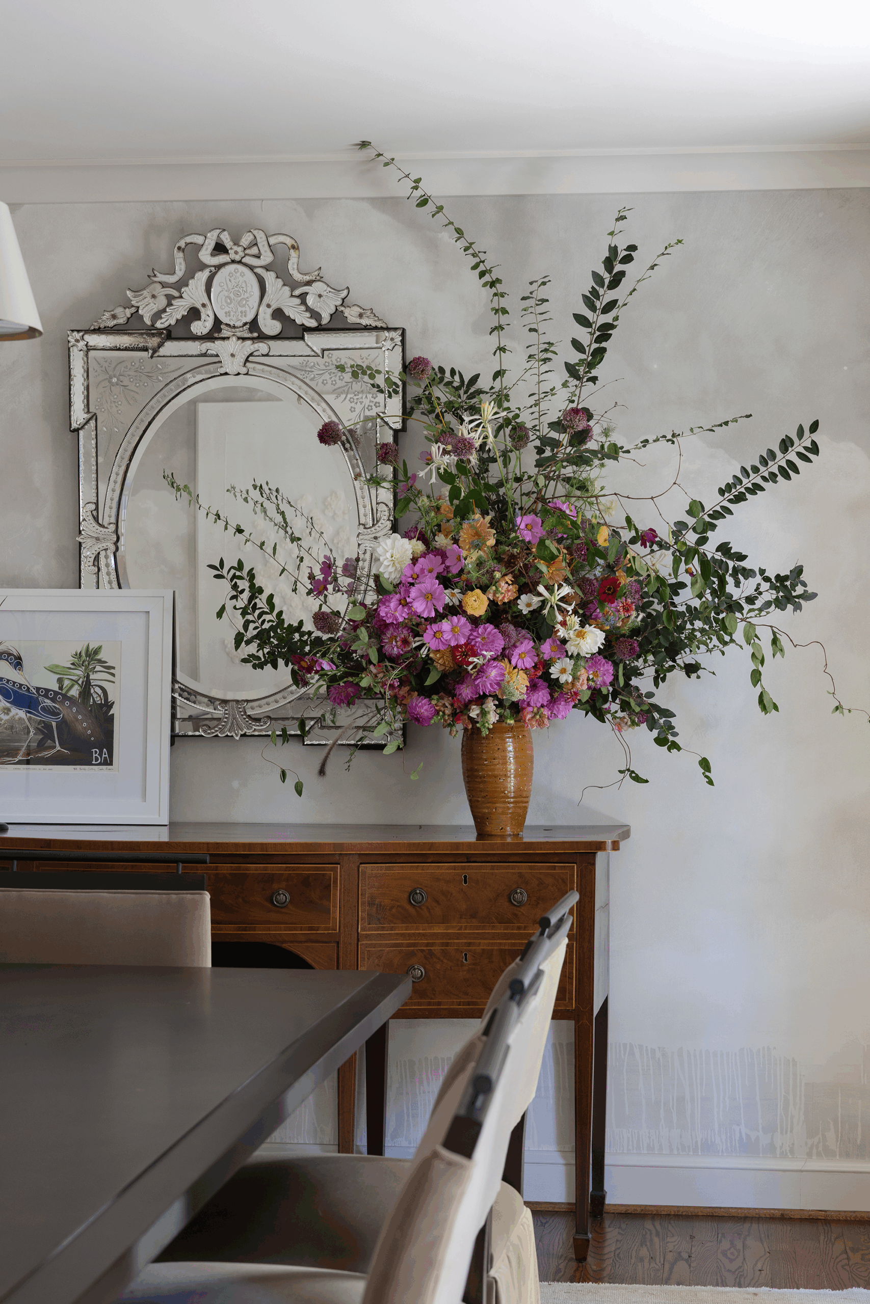 Formal dining room walls covered in dreamy Schumacher wallpaper in a Mountain Brook home