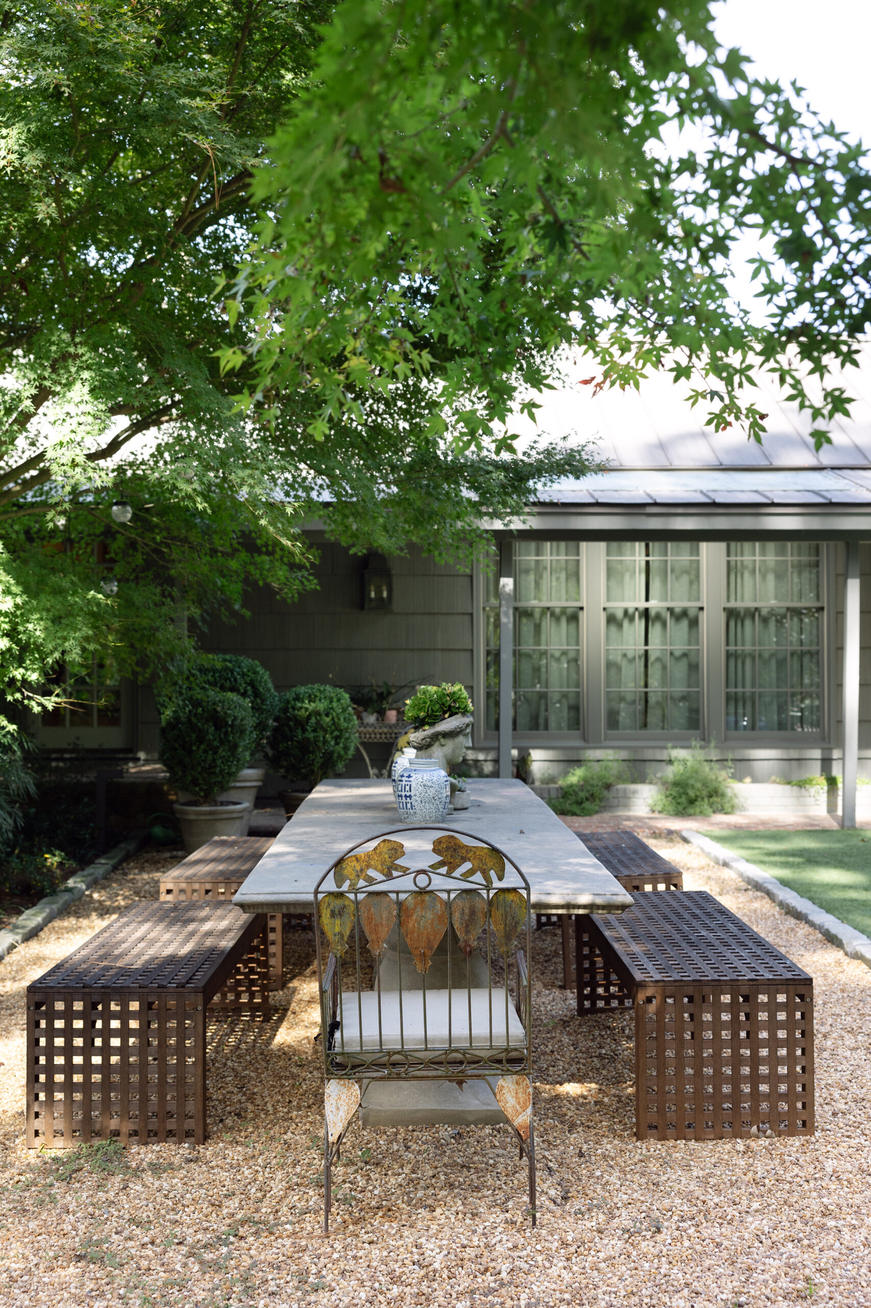 Outdoor dining area surrounded by woods at the Schuster in Mountain Brook home