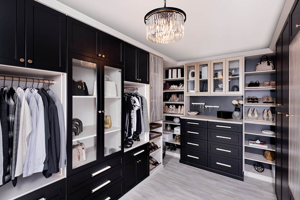 Custom black cabinetry and organized closet designed by Space Cadets